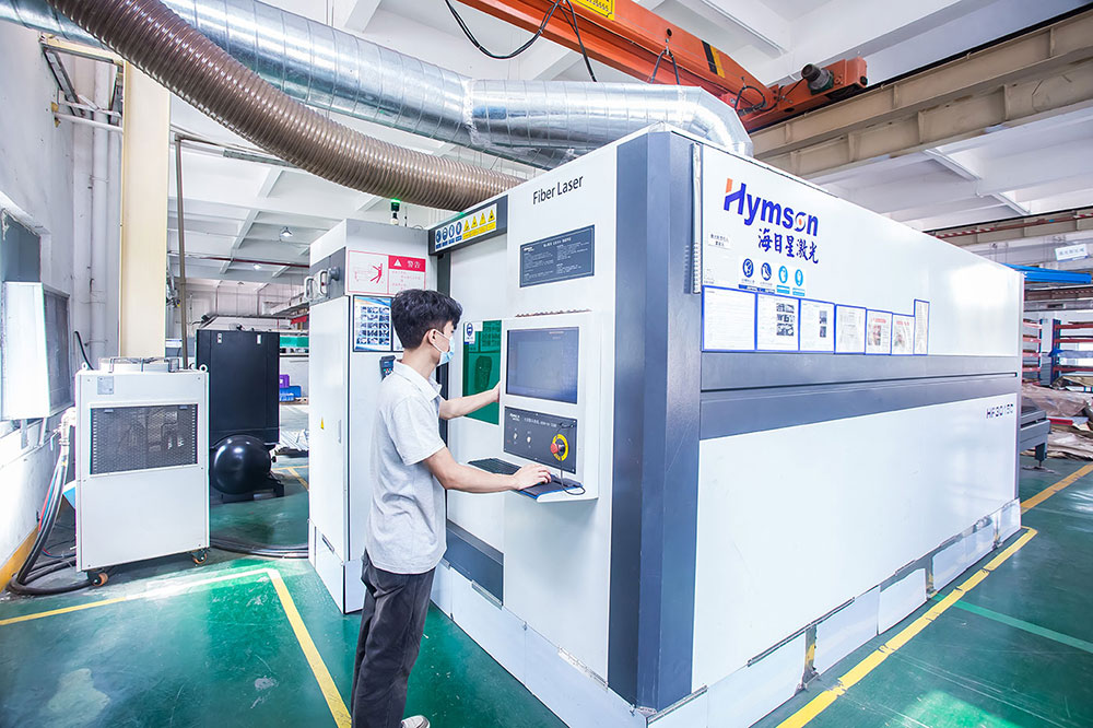 Worker operating laser cutting machine